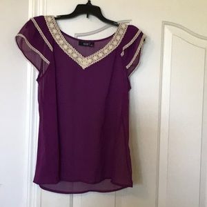 Sexy purple blouse with embroidered neckline.